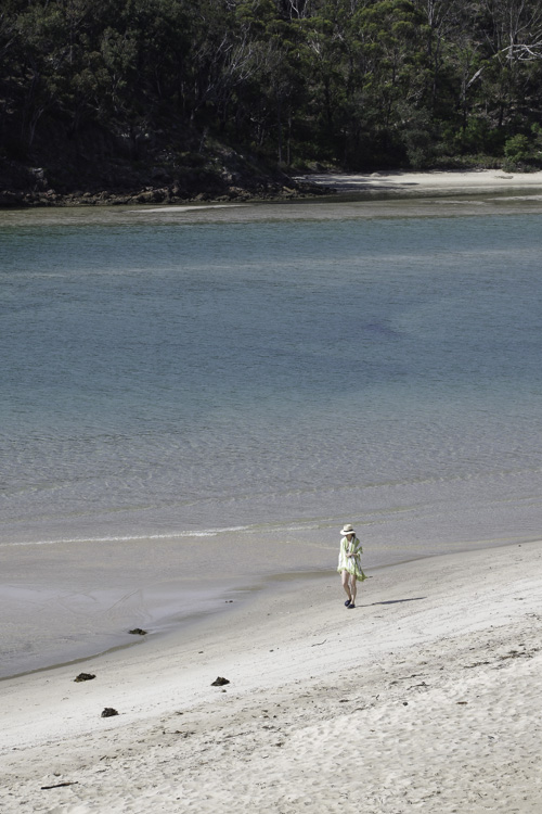 femme marchant au bord de Pambula River en Australie